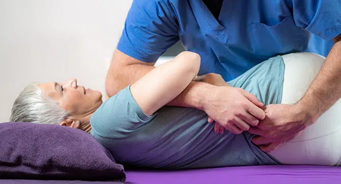 Elderly woman receiving chiropractic treatment at Core Health Chiropractor