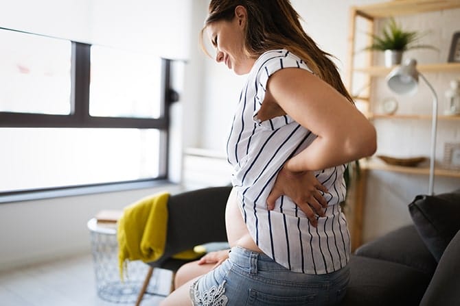 Pregnant woman experiencing pain